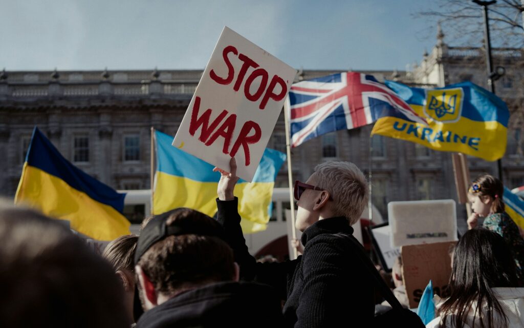 a group of people holding up signs and flags