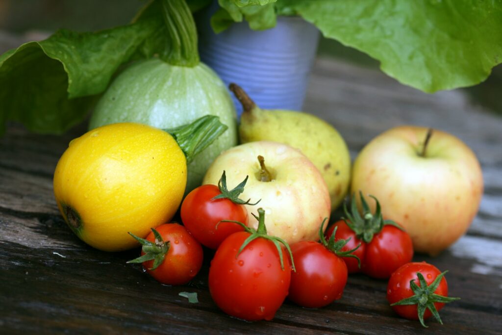 yellow lemon and red tomato on brown wooden table