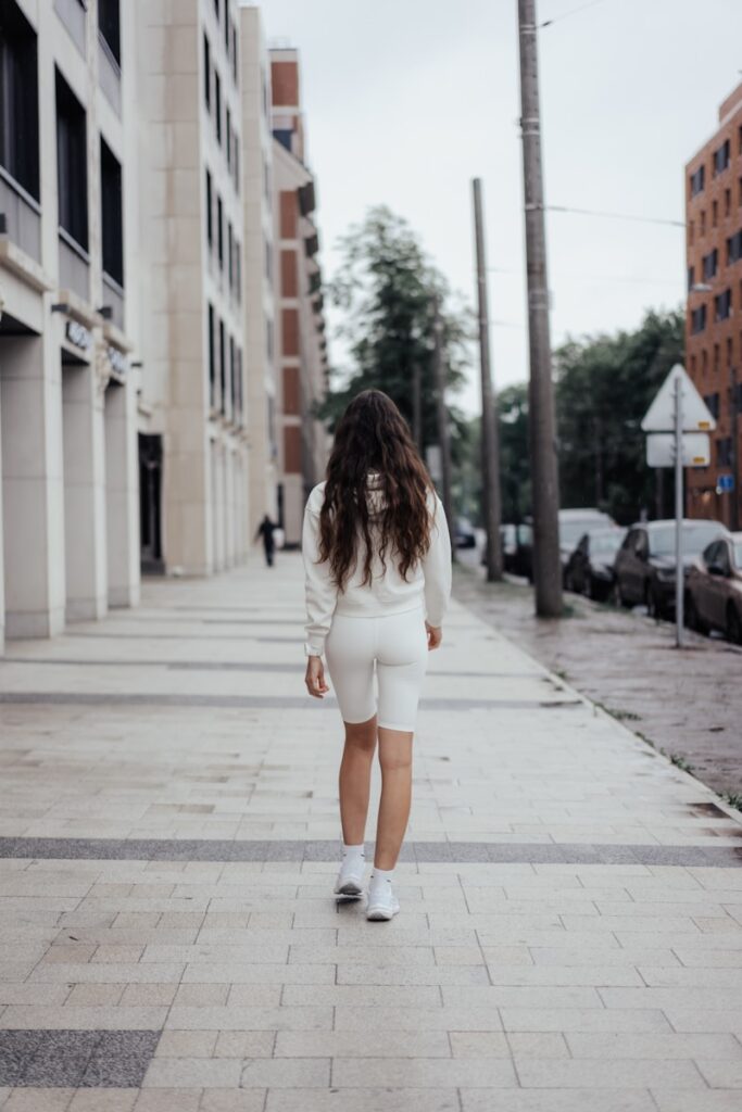 A woman walks down a city street.