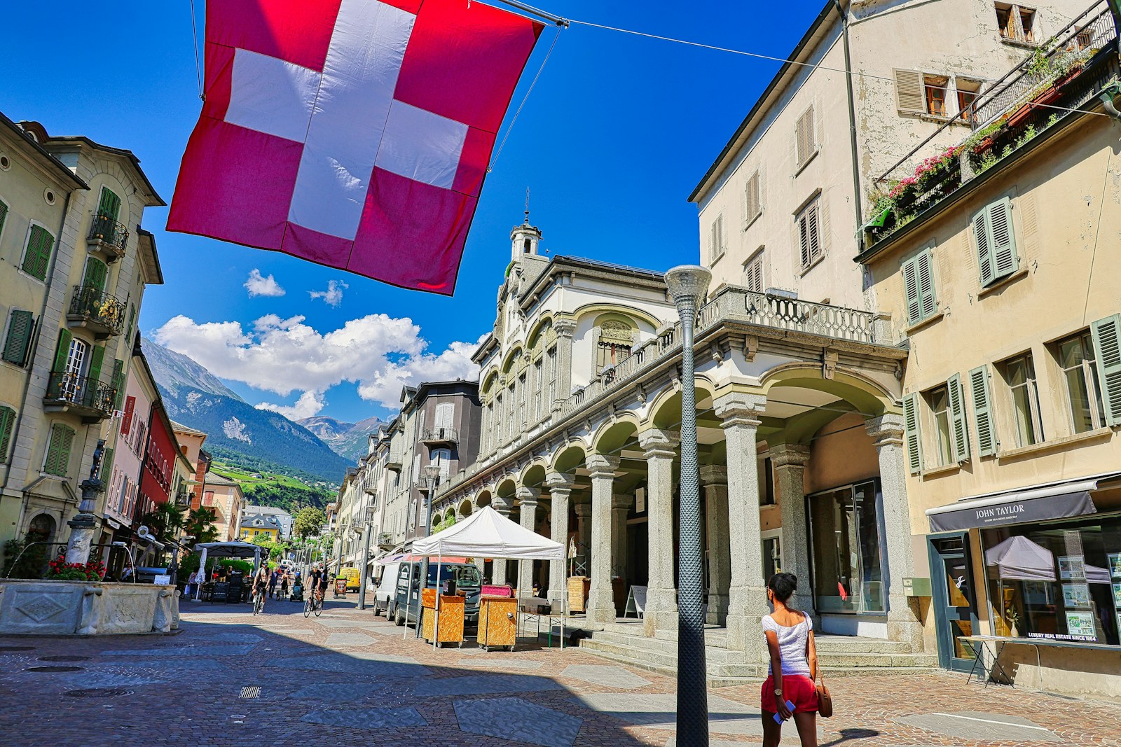 A flag flying in the air over a street