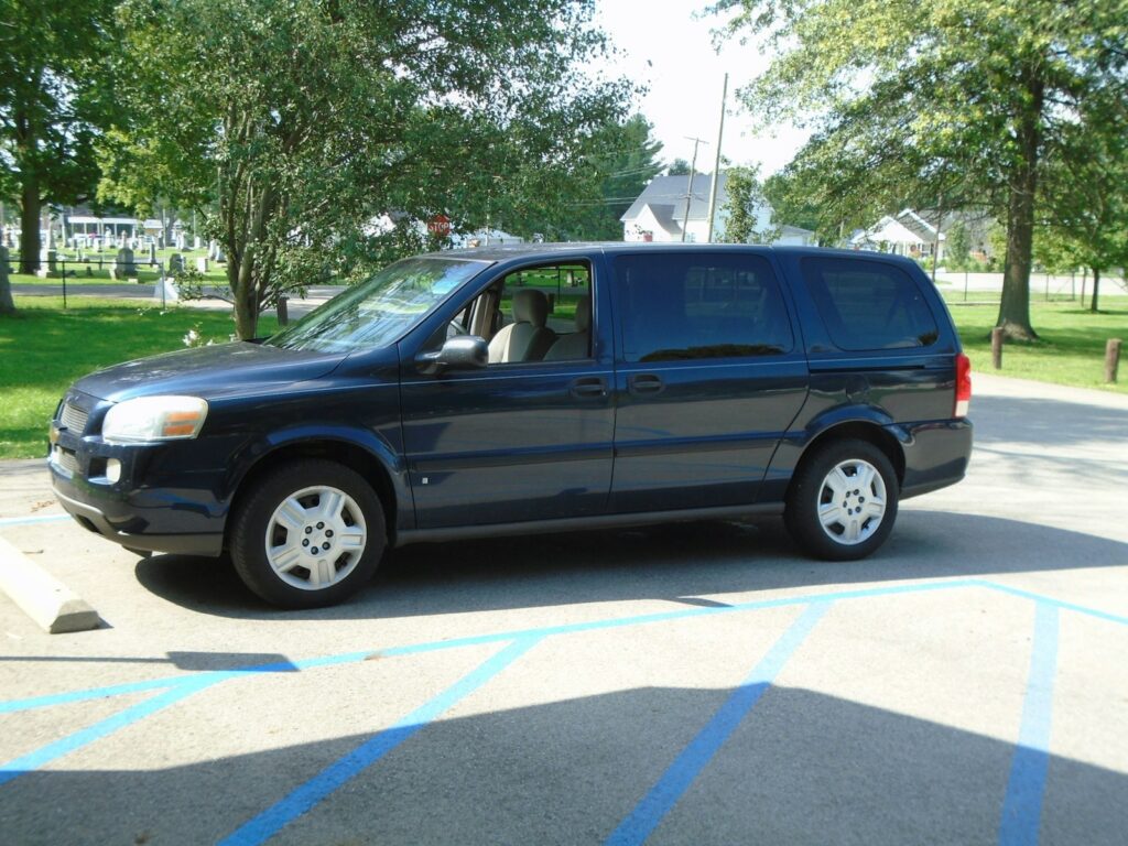 a blue van is parked in a parking lot