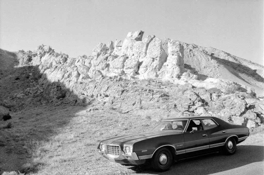 grayscale photo of mercedes benz coupe on road