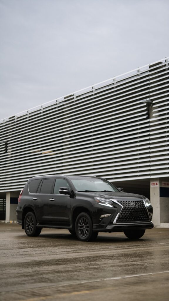 a black suv parked in front of a building