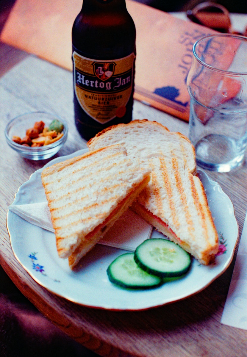 A grilled sandwich with beer.