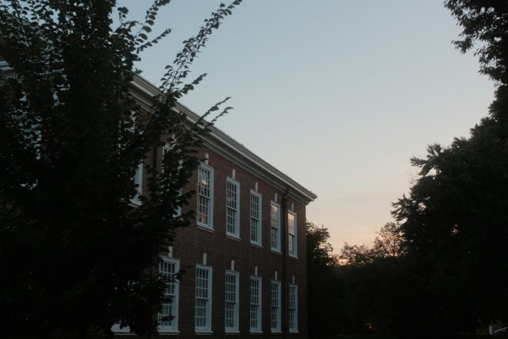 Building exterior with trees against a twilight sky