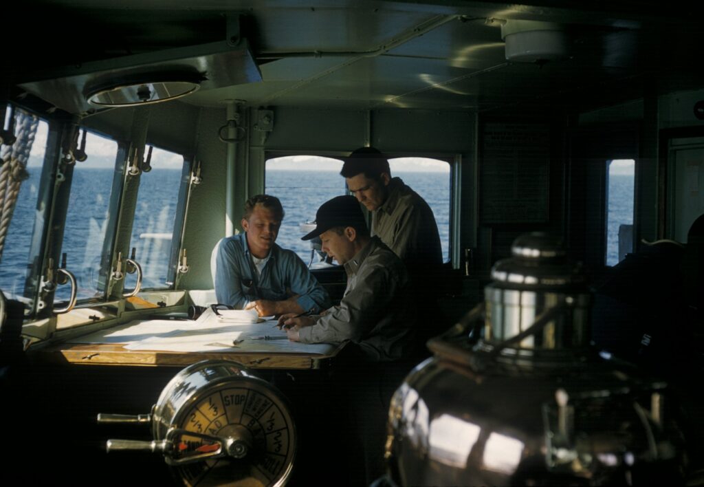 three men inside ships cabin