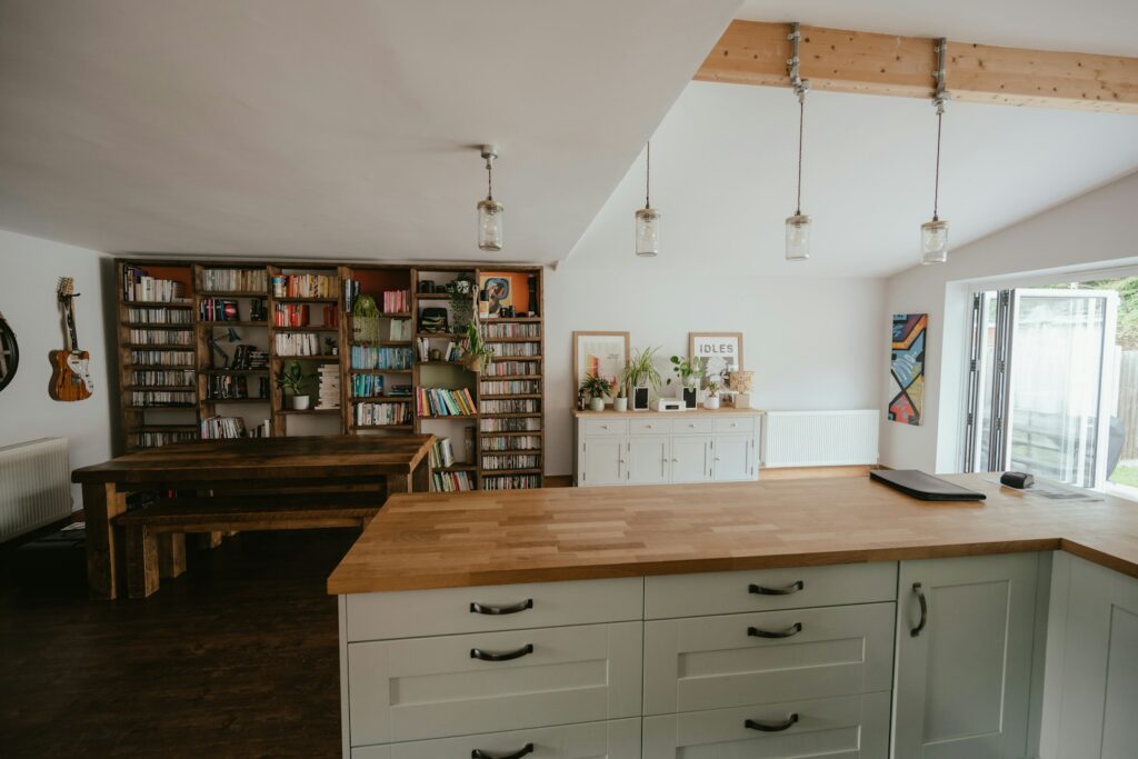 a room with a piano and bookshelves