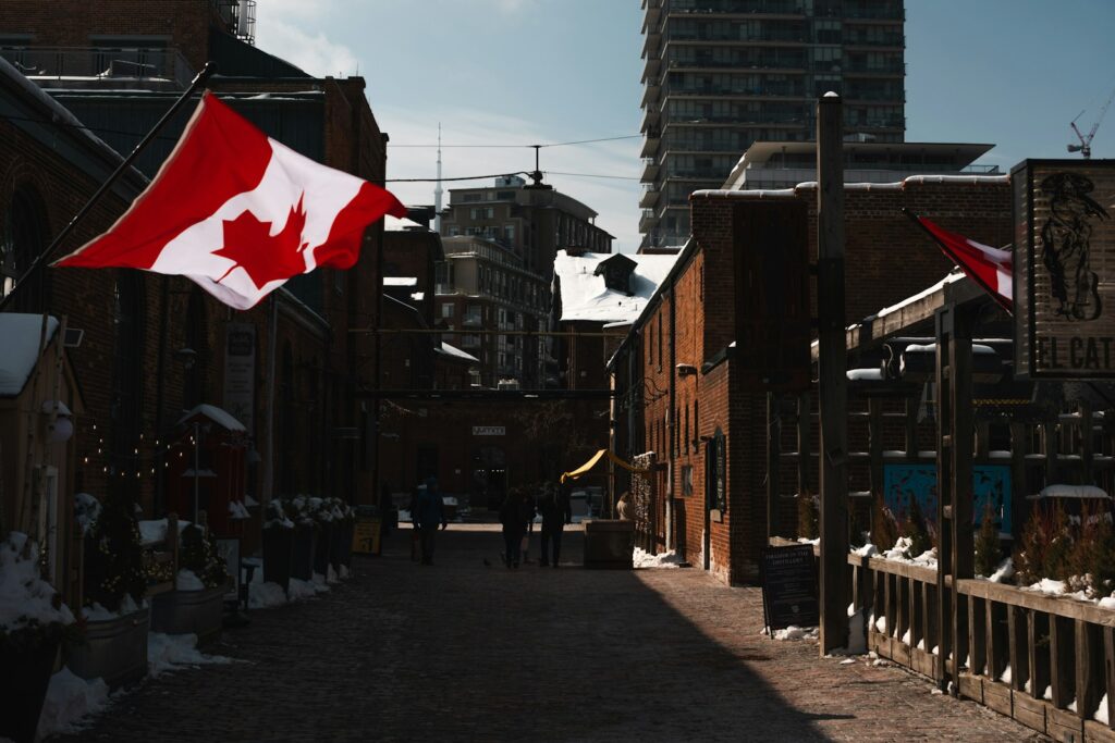 Canadian flags wave above a city street.