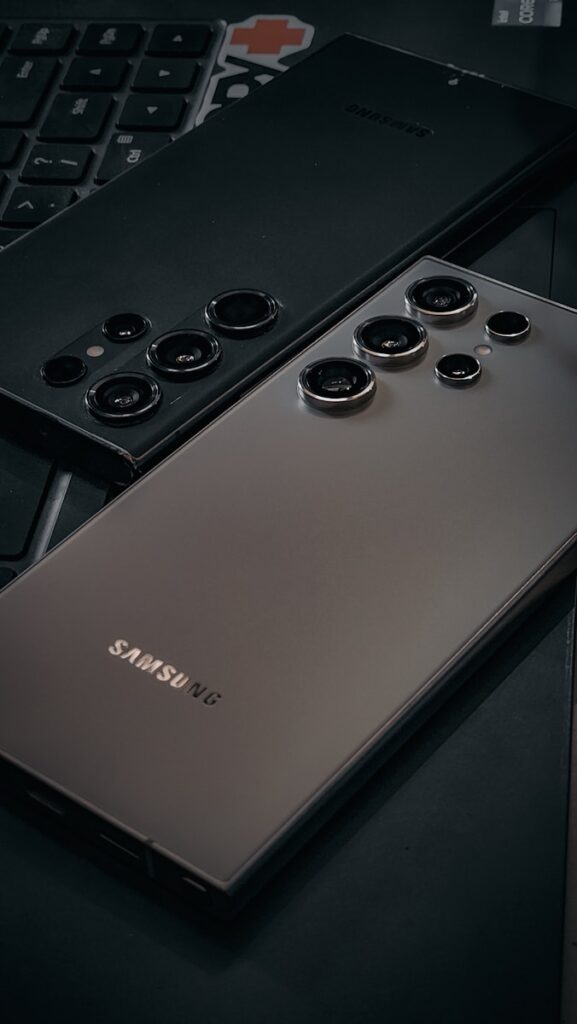 a close up of a cell phone near a keyboard