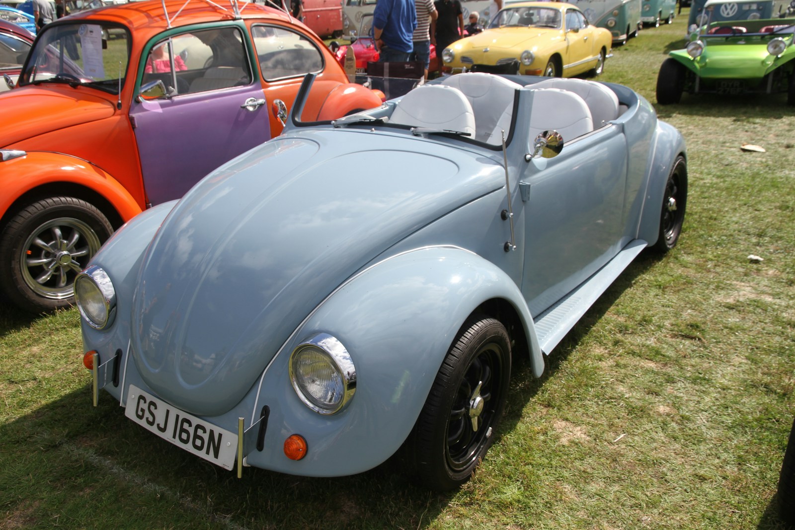 a group of cars parked next to each other on a field
