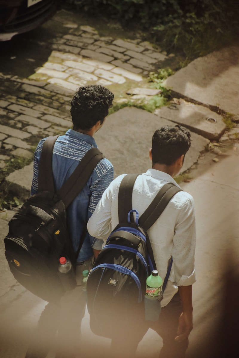 a couple of men walking down a street next to each other