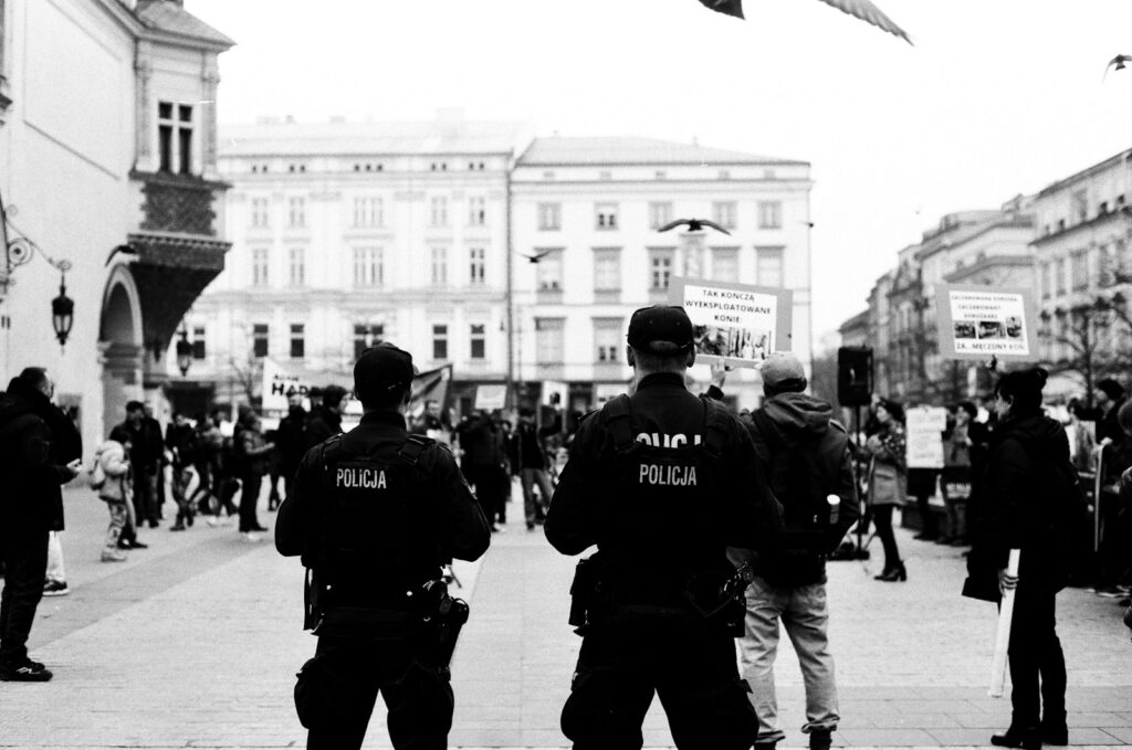 a group of police officers standing on a sidewalk