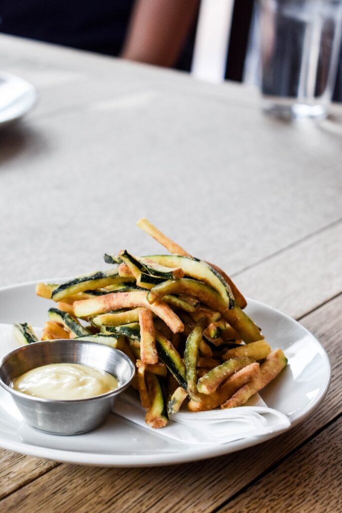 a white plate topped with french fries and dip