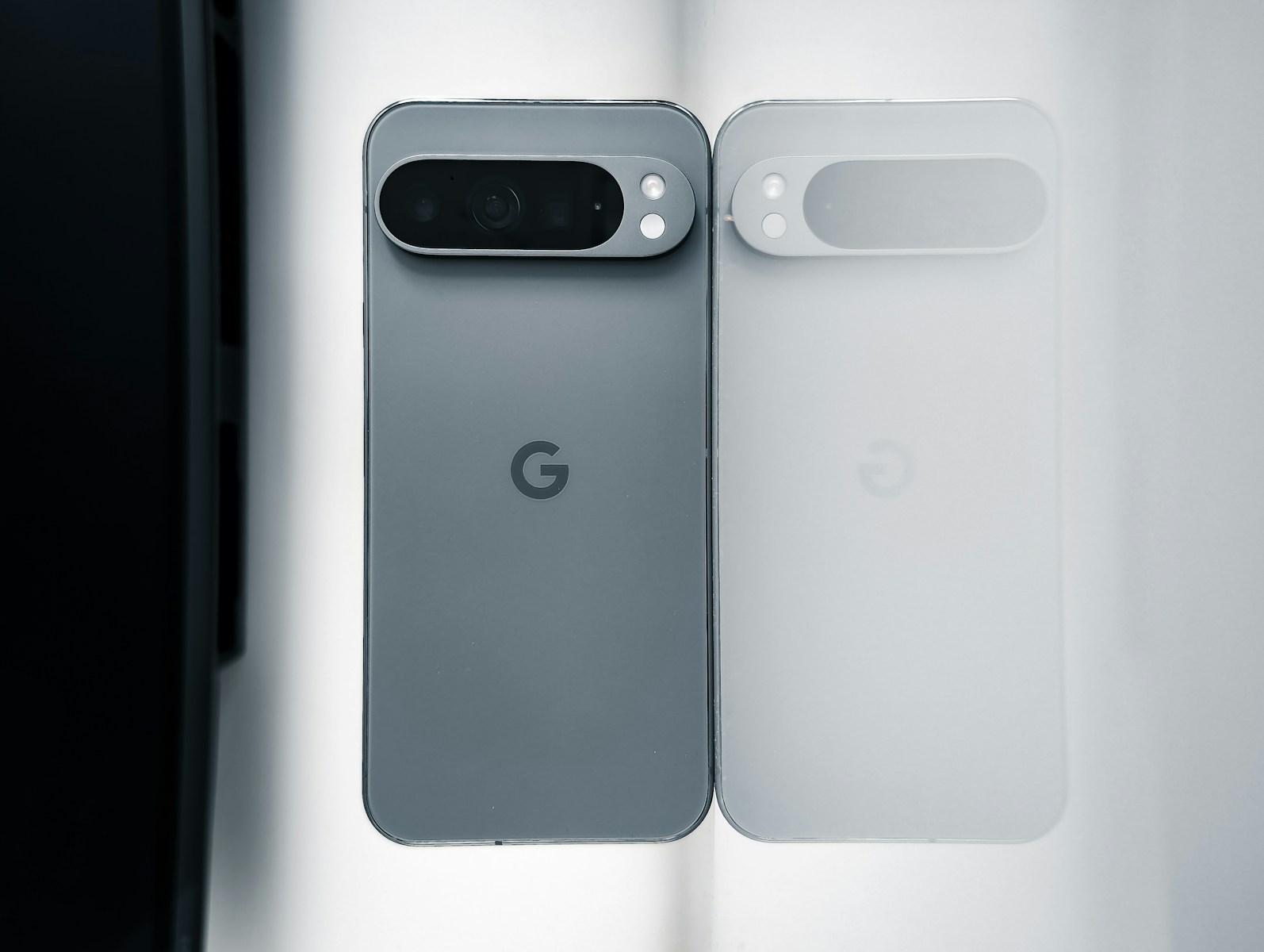 Two cell phones sitting next to each other