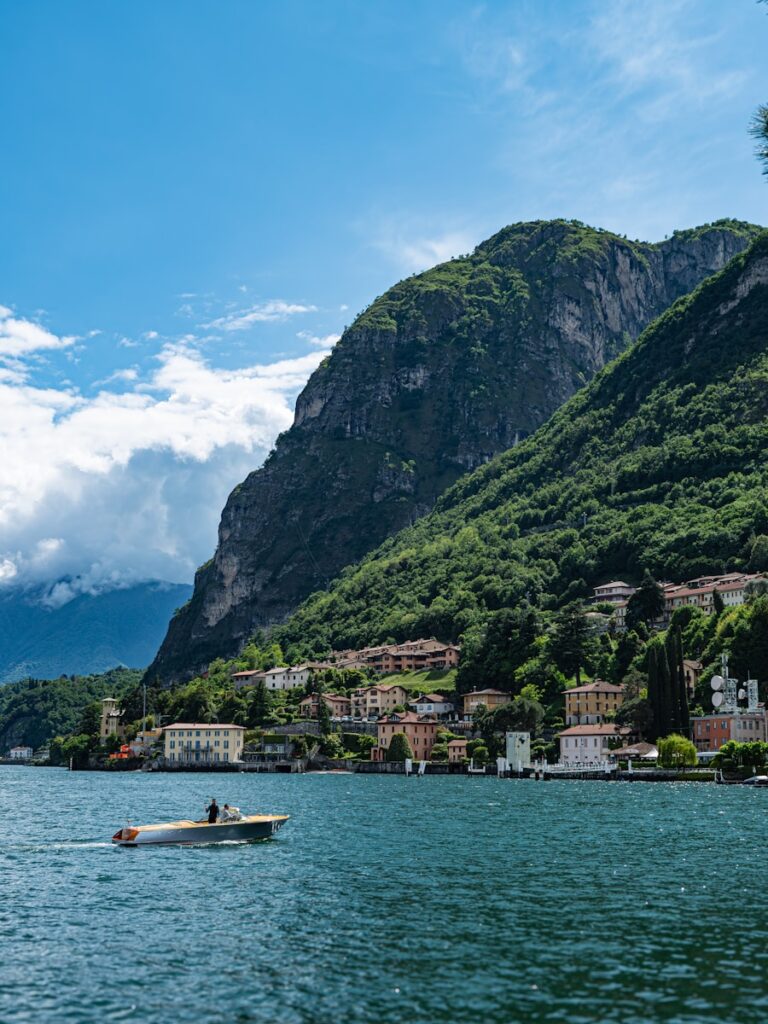 a boat in a body of water with a mountain in the background