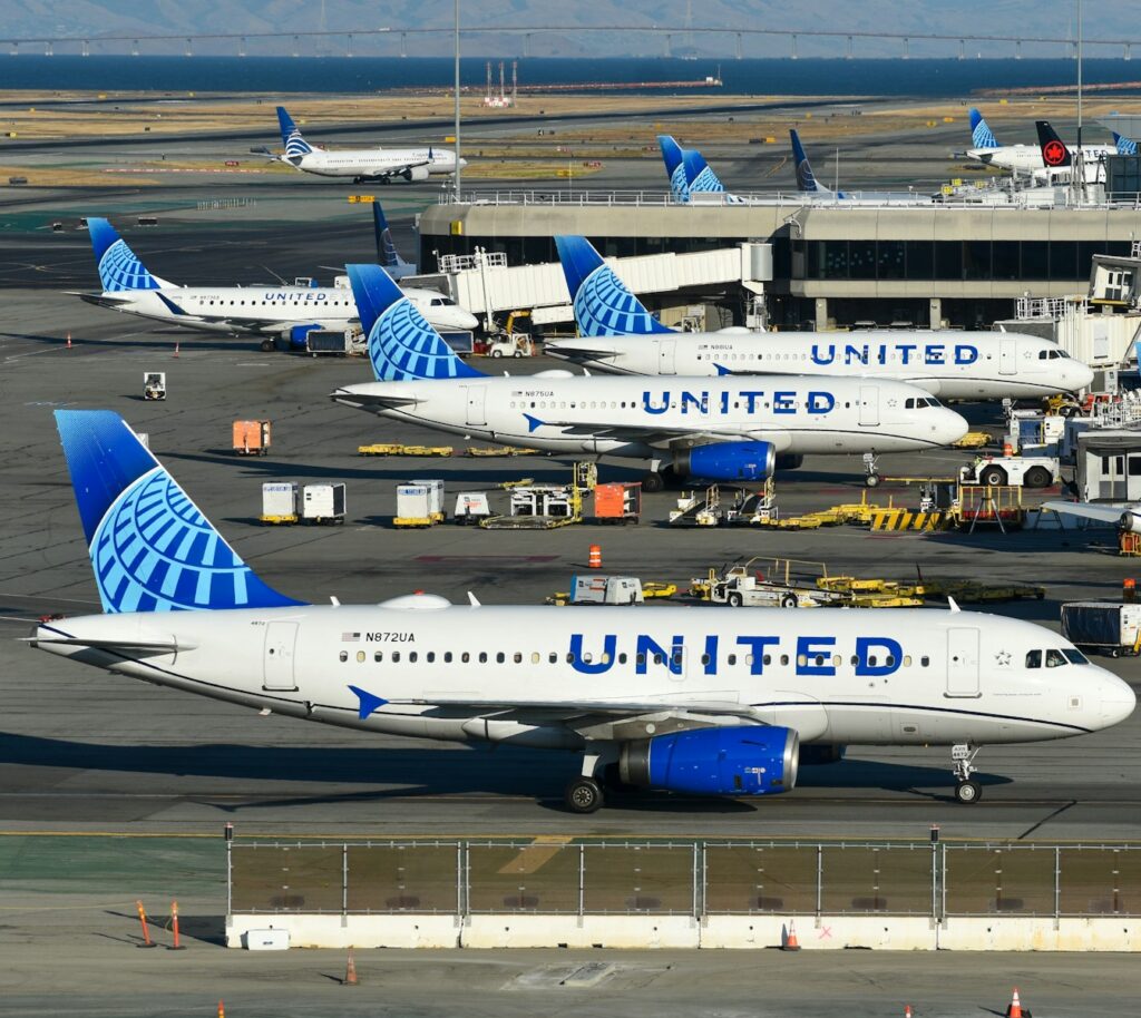 A bunch of airplanes that are on a runway