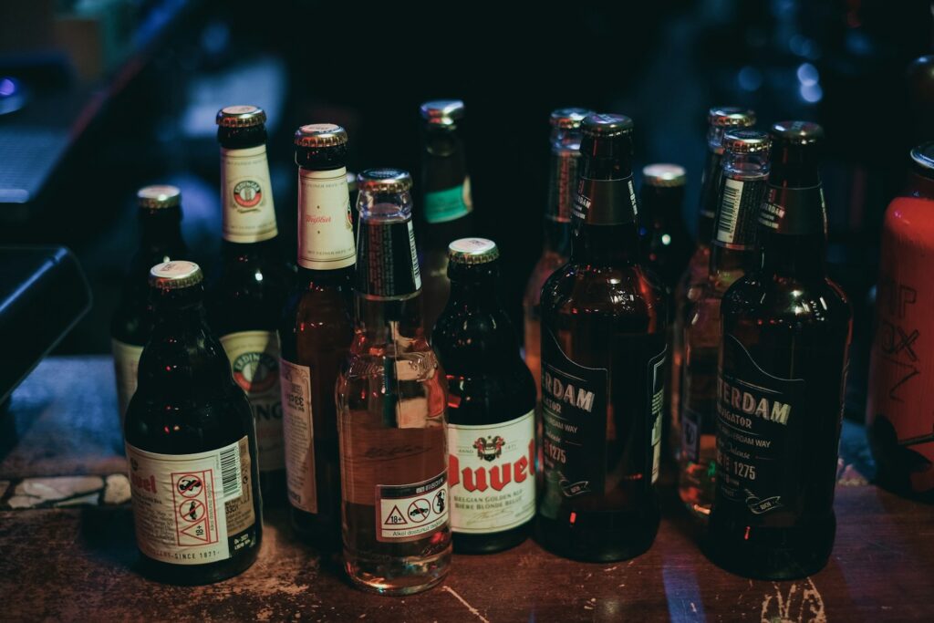 three brown glass bottles on brown marble table