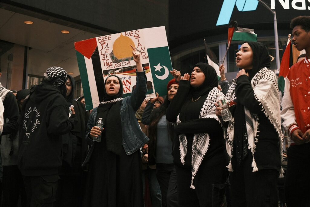 a group of people holding flags and signs