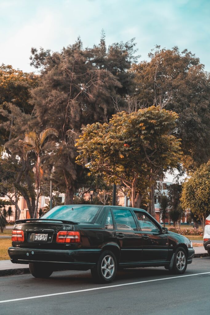 a black car parked on the side of the road