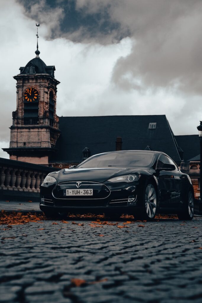 a car parked in front of a building with a clock tower