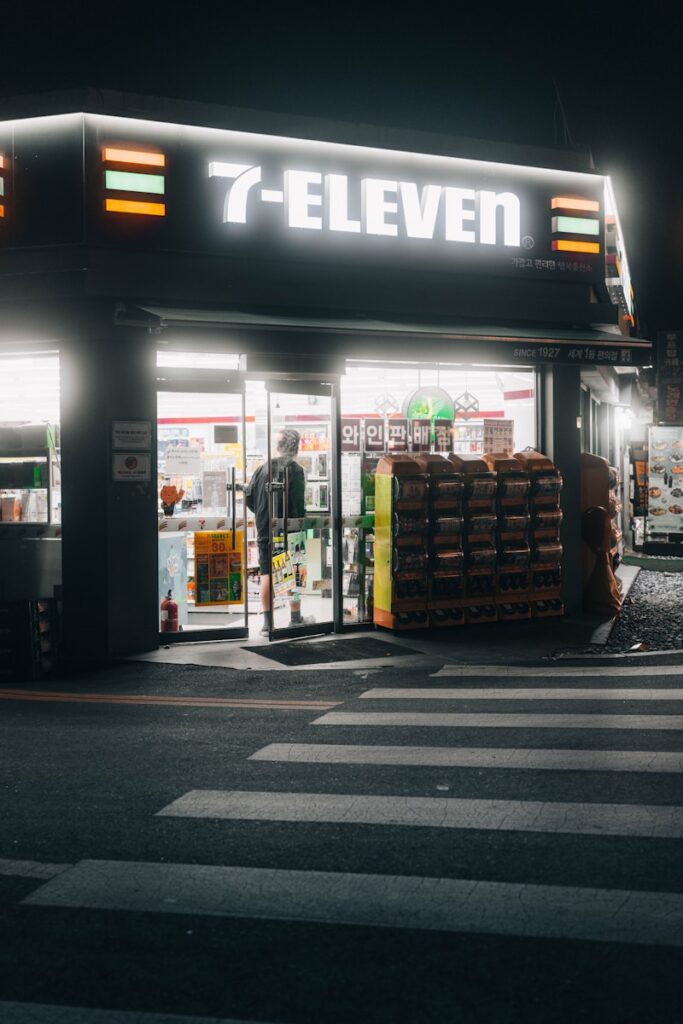 A 7 - eleven store at night with the lights on