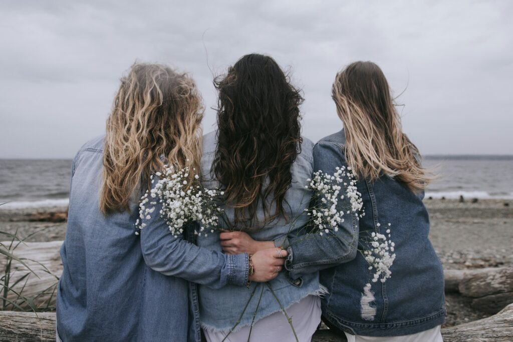 2 women in blue denim jacket