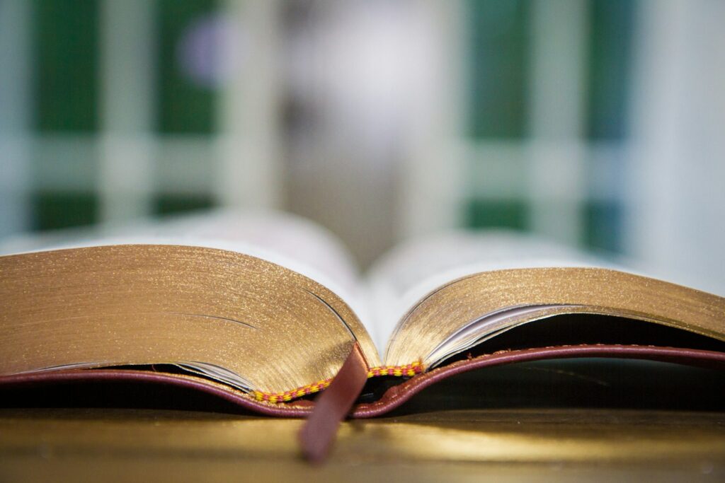 an open book sitting on top of a wooden table