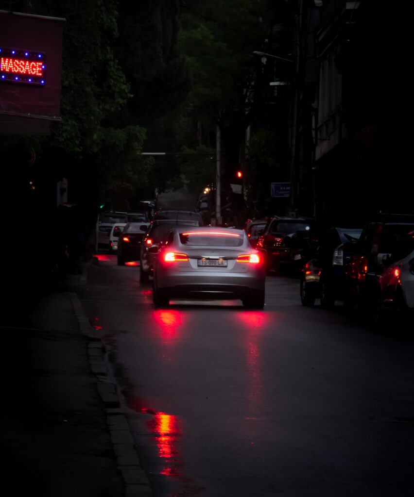 a car that is sitting in the street at night