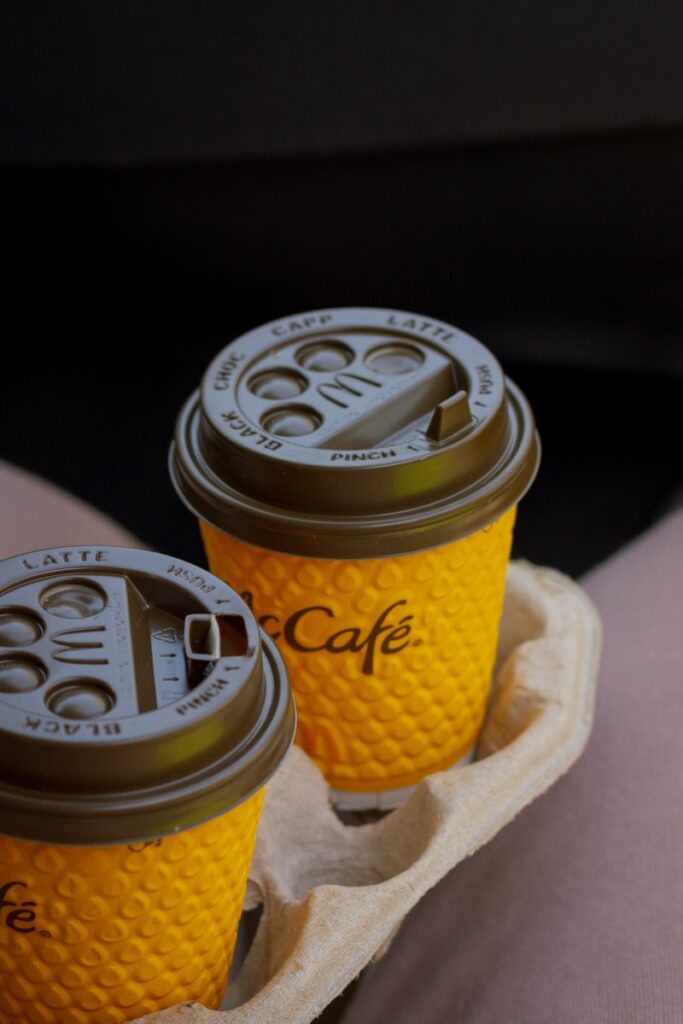 two cups of coffee sitting on a tray