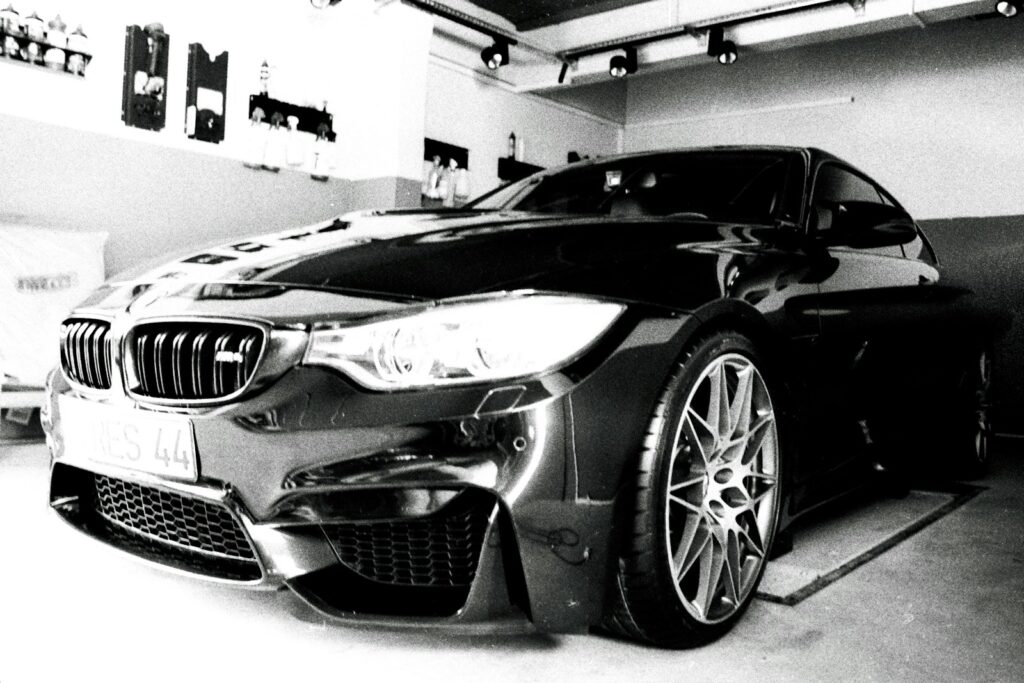 a black and white photo of a car in a garage