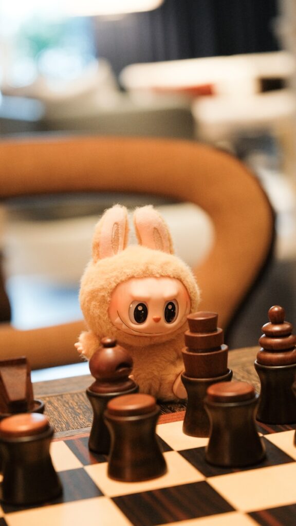 A rabbit toy watches a chess match.
