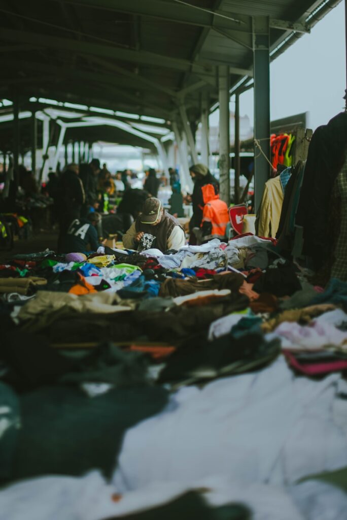 A group of people standing around a pile of clothes