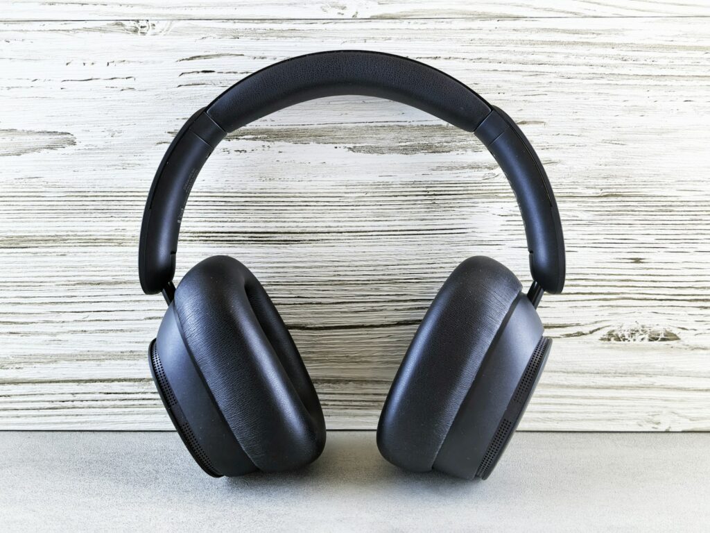 Black headphones rest on a light colored surface.