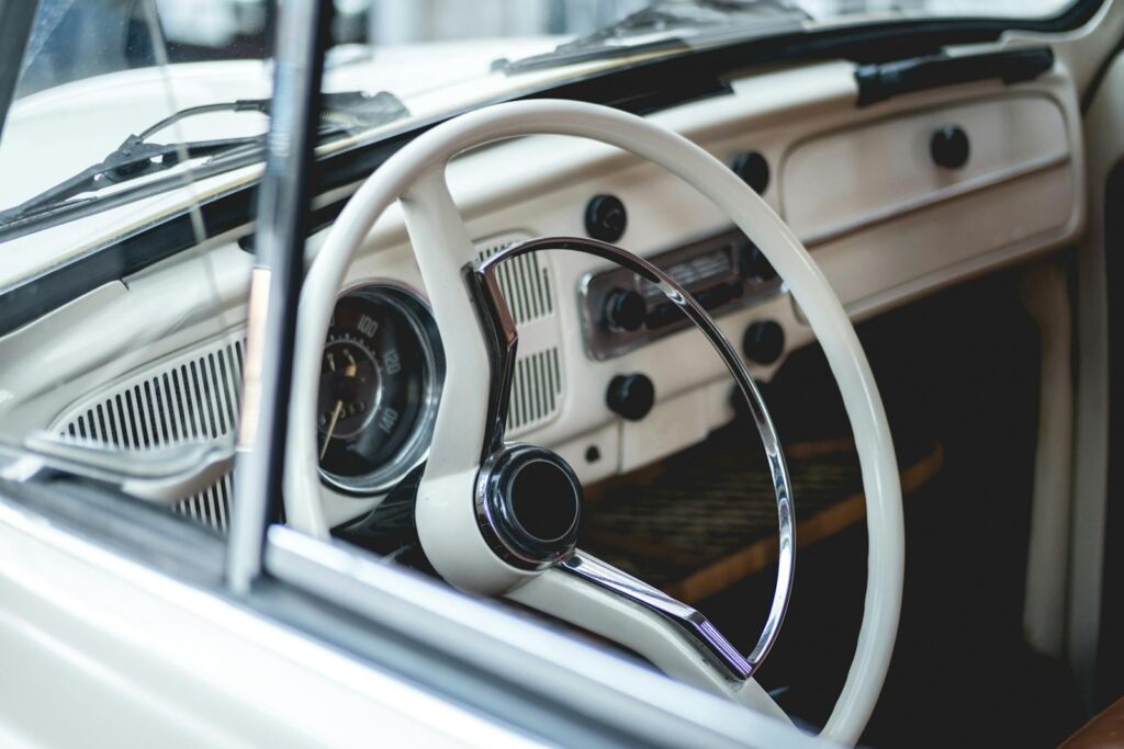 Explore the classic design of a vintage Volkswagen Beetle interior with retro steering wheel and dashboard.