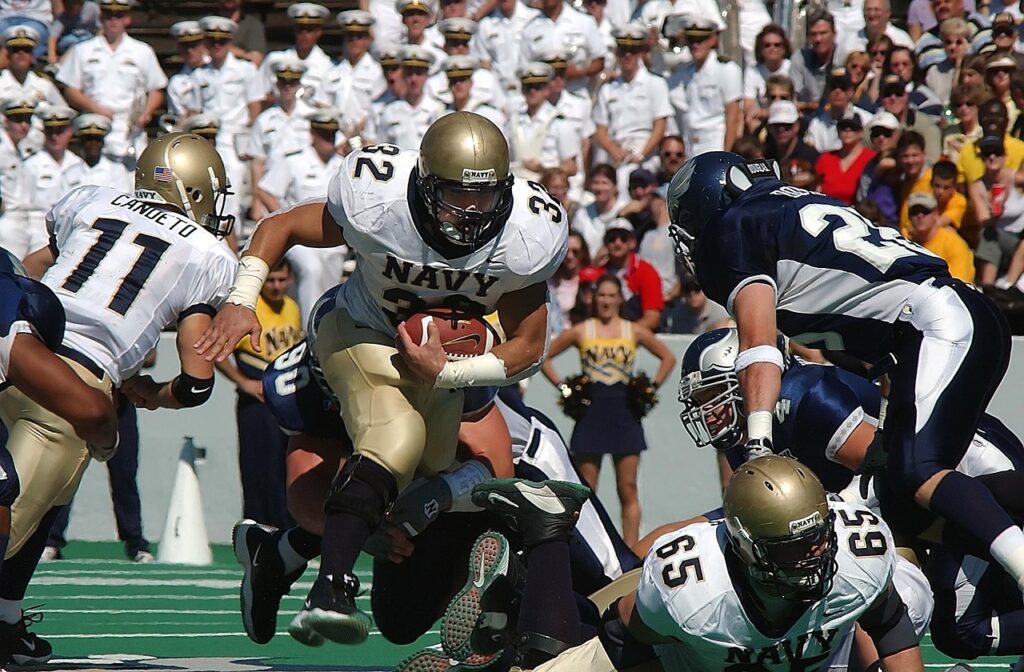 american football, football, football game, running back, ball carrier, american football field, team, competition, game, sport, football american, player, football player, grass, college, nature, pigskin, athlete, football helmet, offense, green, teamwork, athletics, helmet, action, action photo, blocking, lineman, outdoors, playing, college football, muscular, football stadium, football fans, team sport, competitive, gridiron, spectators