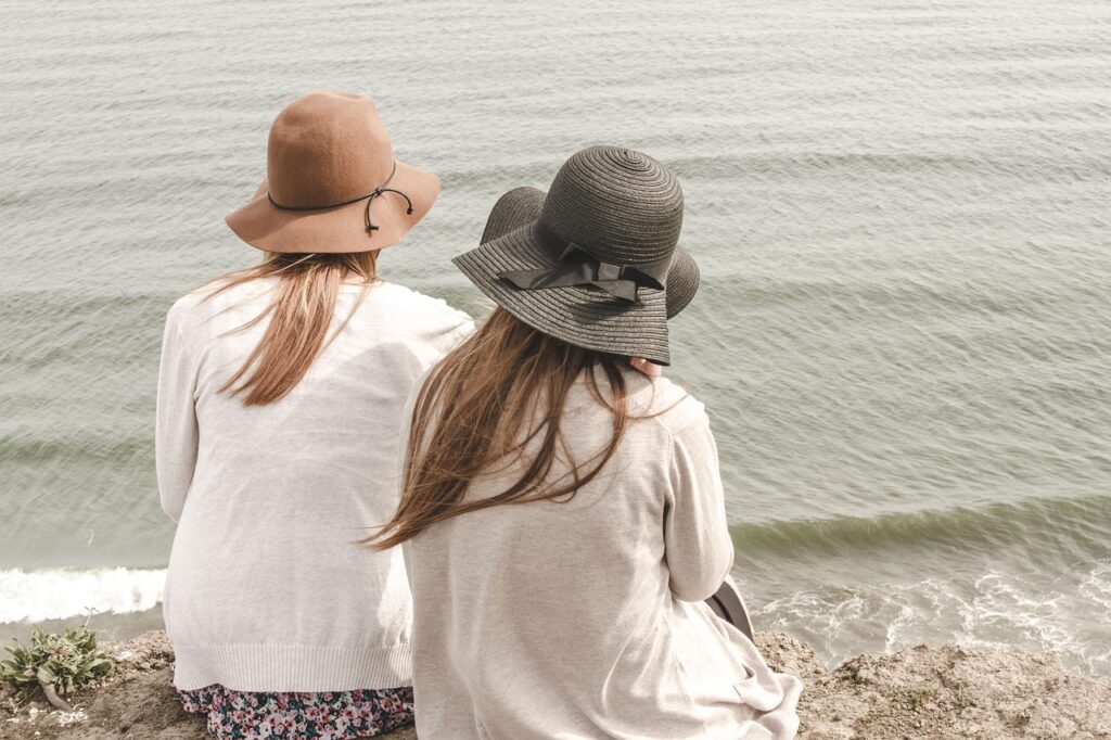 beach, hats, women, pair, couple, fashion, style, stylish, backs, young women, shore, seashore, friendship, girl friends, nature, ocean, outdoors, people, sand, sea, water, friends