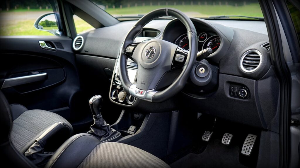 Detailed view of a modern car's interior featuring the steering wheel and dashboard.