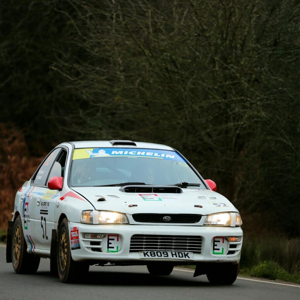 rally car driving though a forest