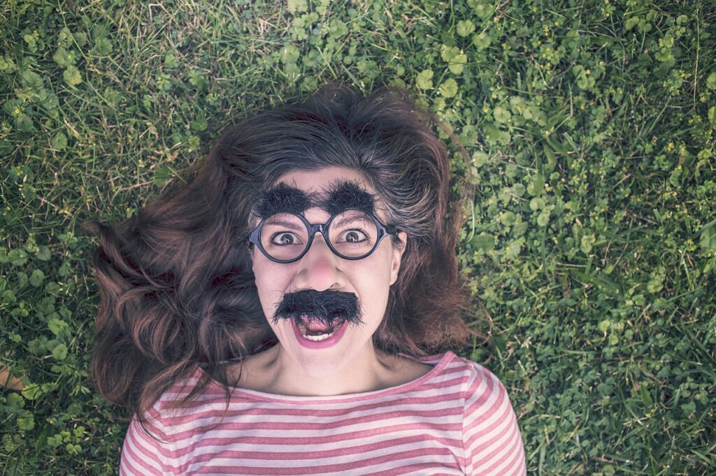 grimace, funny, expression, mask, happy, queer, people, portrait, person, emotion, fun, adult, man, human, hair, face, head, happiness, cheerful, grass, nature, girl, woman, glasses, frames, brunette, eyebrows, moustache, green happy, green grass, green funny, green portrait, green glass, green frame, green hair, green human, green glasses, green happiness, green fun