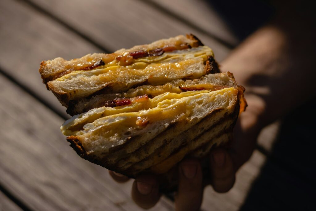 person holding a brown pastry