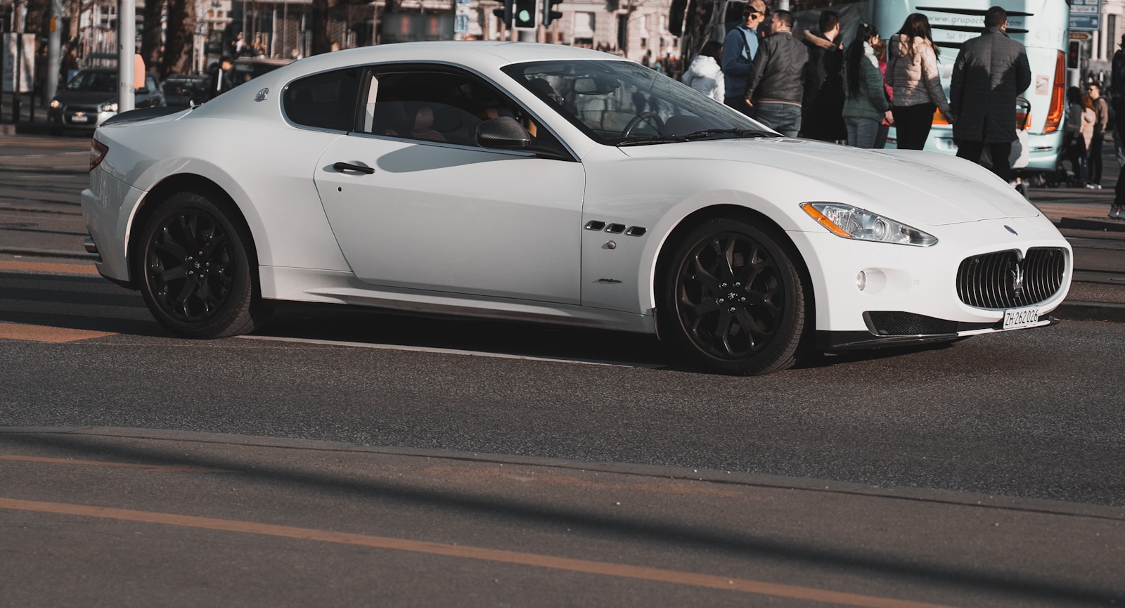 a white sports car parked on the side of the road