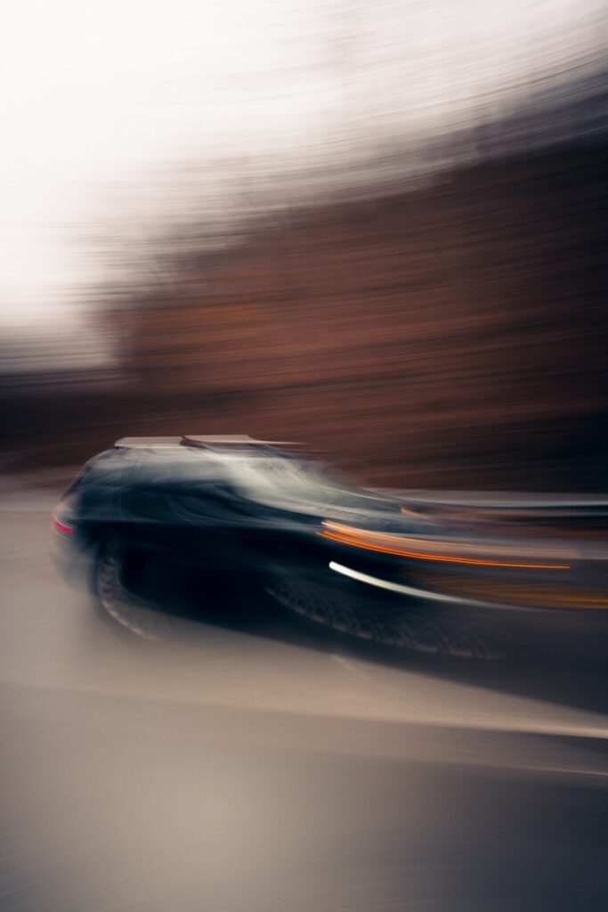 A blurry photo of a car driving down the road