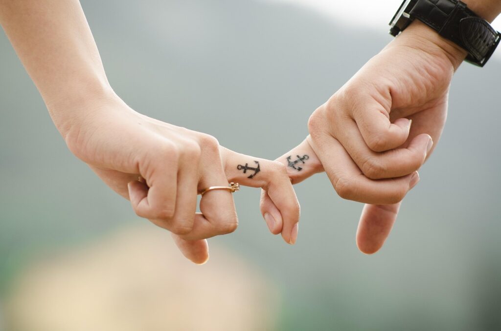 valentines day background, couple, hands, tattoos, fingers, intertwined, anchor tattoos, lovers, together, touch, relationship, closeup