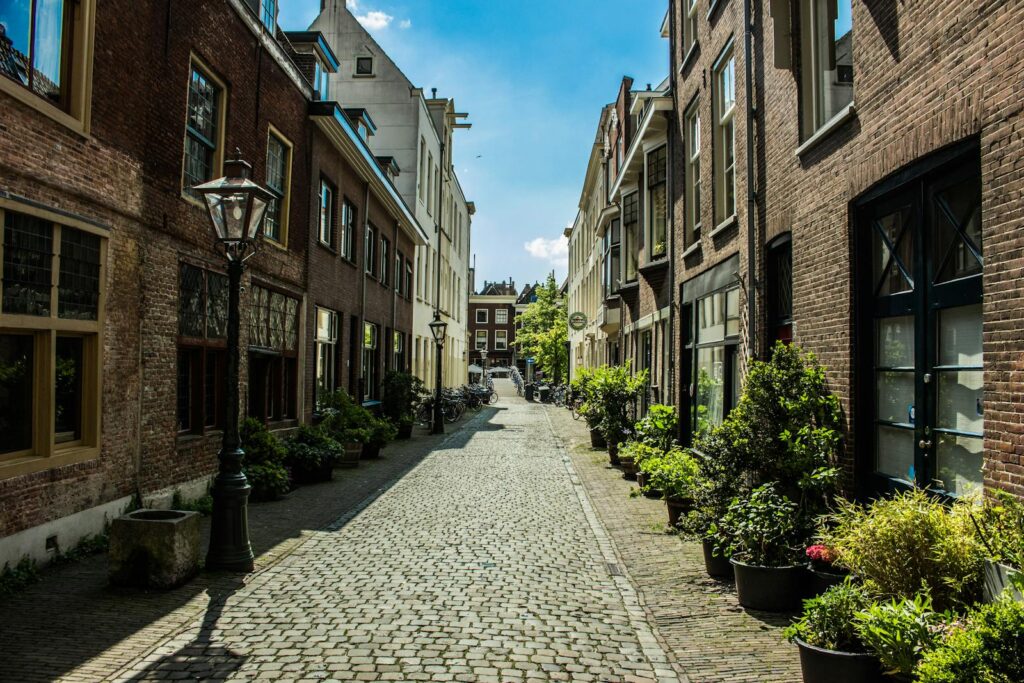 Picturesque cobblestone street with classic Dutch architecture in Leiden, Netherlands.