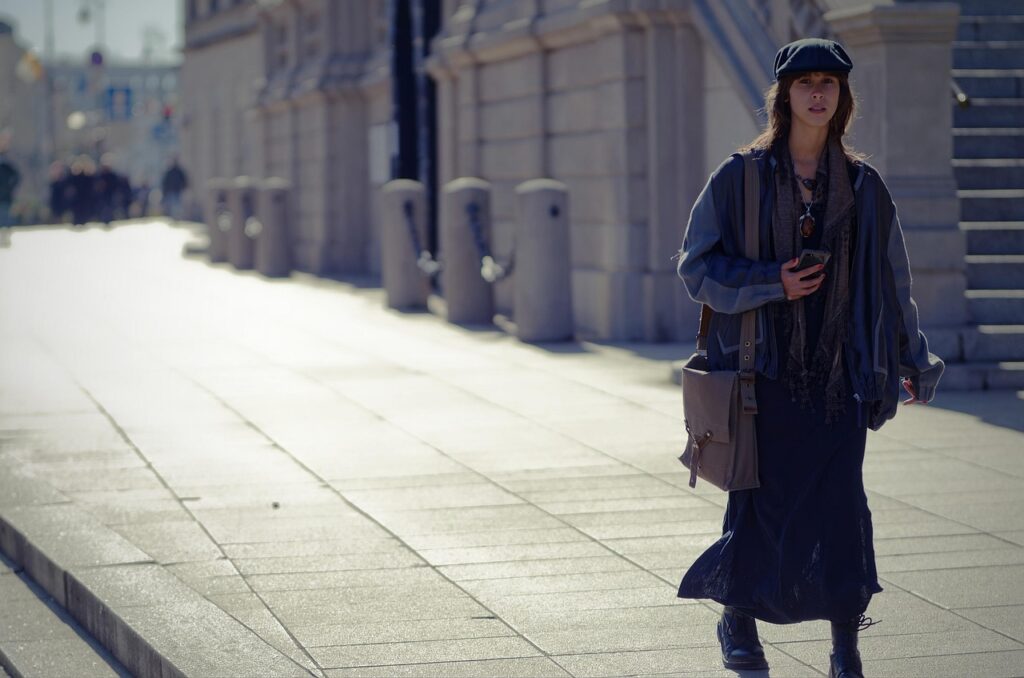 fashion, purse, urban, city, woman, casual, caucasian, walking, pavement, sidewalk, street, buildings, cap, bag, sunny, snapshot, street photography, autumn, pretty