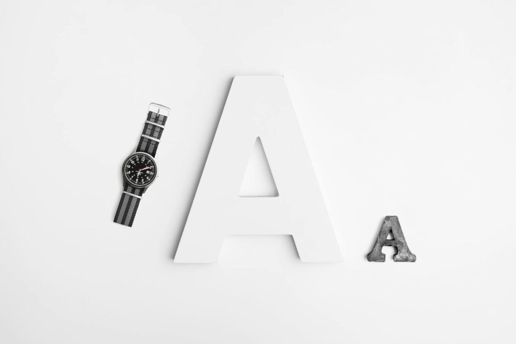 Minimalist layout featuring typography with a sleek watch and bold letter A design.