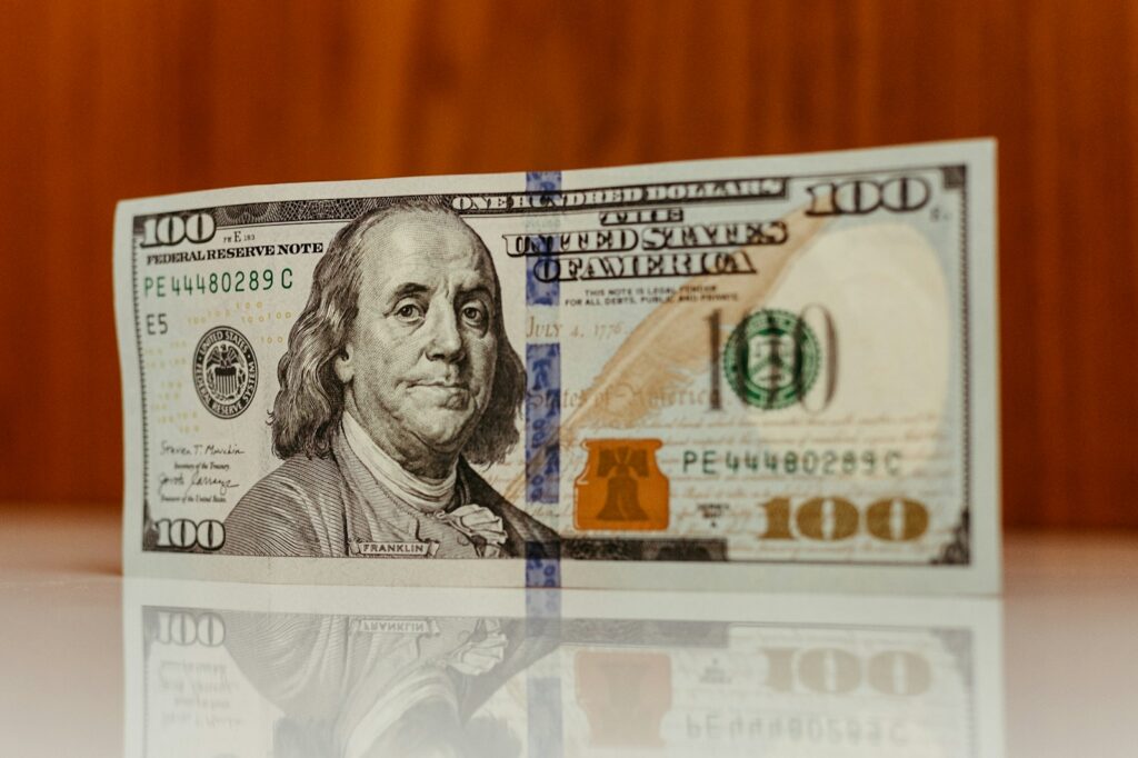 a one hundred dollar bill sitting on top of a table