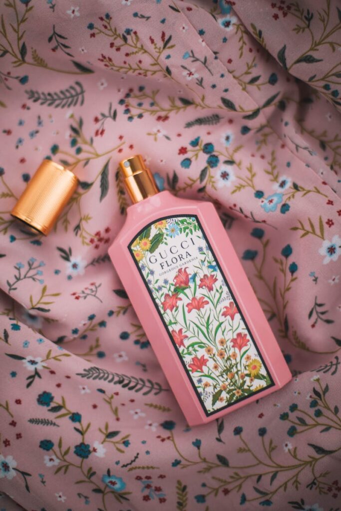 Elegant Gucci Flora perfume bottle on floral patterned fabric for beauty and lifestyle.
