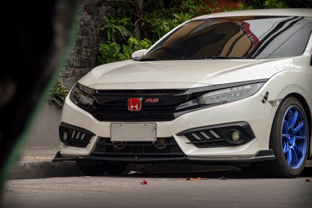A white car parked on the side of a road