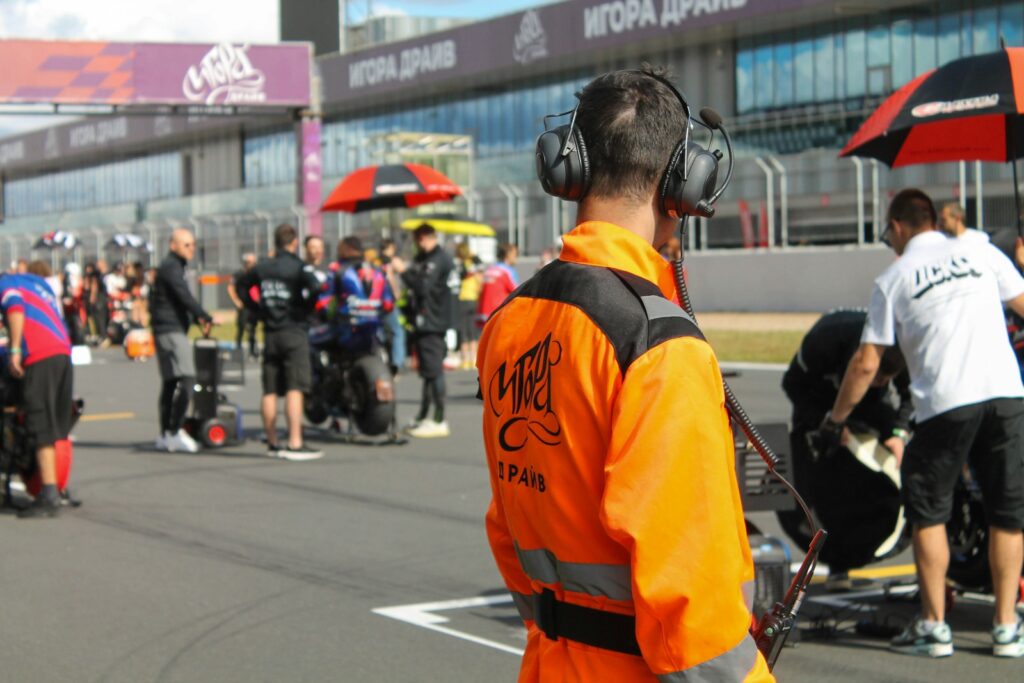 Race official in orange vest on track